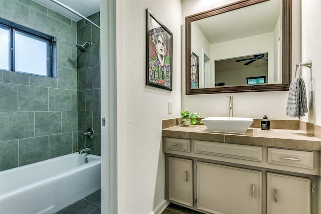 7509 Spring Meadow Ln, Garland, TX 75044 - bathroom with bathing tub / shower combination, tile patterned floors, vanity, and ceiling fan