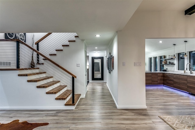 7509 Spring Meadow Ln, Garland, TX 75044 - entrance foyer featuring light wood finished floors, stairs, baseboards, and recessed lighting