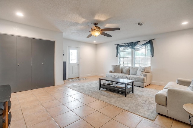 living area featuring light tile patterned flooring, ceiling fan, visible vents, and recessed lighting