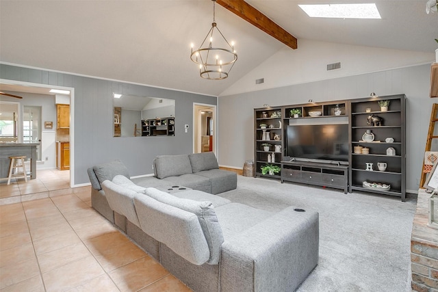 living area featuring visible vents, an inviting chandelier, light tile patterned floors, and vaulted ceiling with skylight