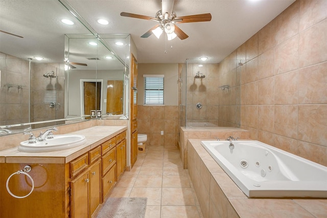 bathroom featuring a tub with jets, ceiling fan, recessed lighting, tile patterned floors, and a sink