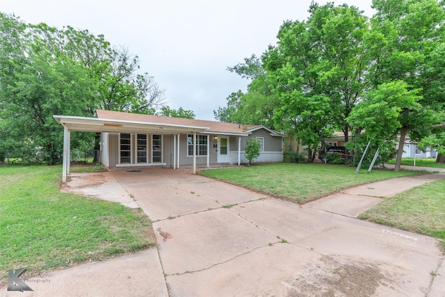 2317 Yorktown Dr, Abilene, TX 79603 - ranch-style house with a porch, a carport, driveway, and a front lawn