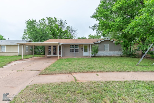 2317 Yorktown Dr, Abilene, TX 79603 - ranch-style home featuring a carport, a front lawn, and concrete driveway