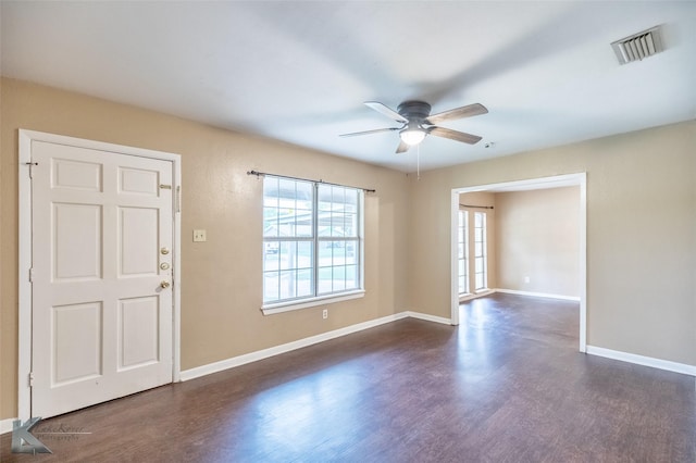 2317 Yorktown Dr, Abilene, TX 79603 - unfurnished room featuring visible vents, dark wood-style flooring, ceiling fan, and baseboards