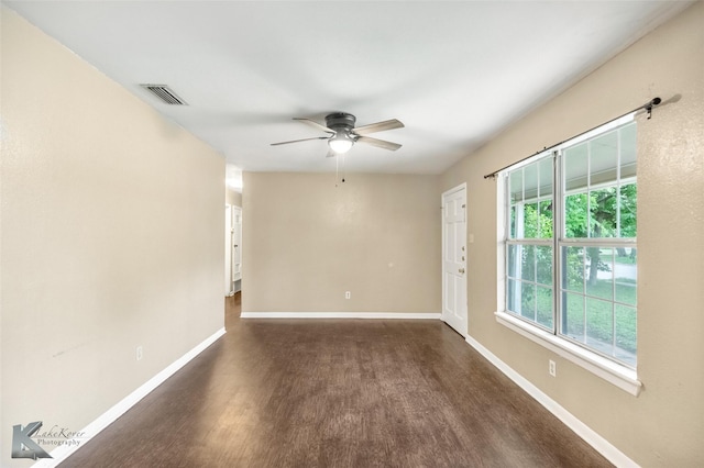 2317 Yorktown Dr, Abilene, TX 79603 - spare room featuring visible vents, a ceiling fan, baseboards, and dark wood-style floors