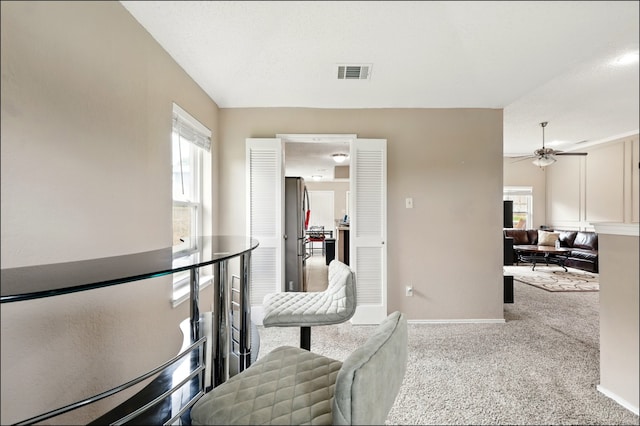 corridor with healthy amount of natural light, carpet flooring, and baseboards