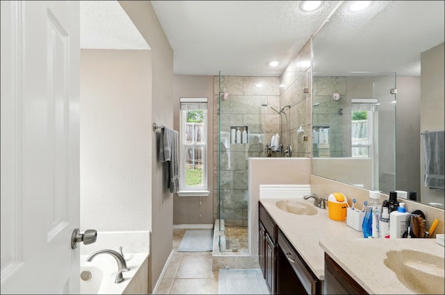 full bath with a stall shower, double vanity, a bath, tile patterned flooring, and baseboards