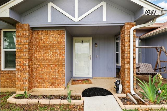 property entrance with brick siding