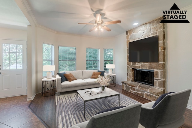 315 Lakeside Dr, Rockwall, TX 75032 - living room featuring a stone fireplace, ceiling fan, crown molding, baseboards, and wood finished floors