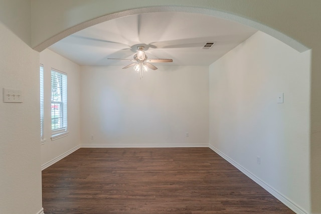 315 Lakeside Dr, Rockwall, TX 75032 - unfurnished room featuring ceiling fan, dark wood-style flooring, arched walkways, and baseboards