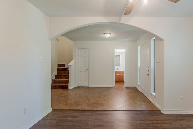315 Lakeside Dr, Rockwall, TX 75032 - entrance foyer featuring arched walkways, stairway, a ceiling fan, dark tile patterned floors, and baseboards