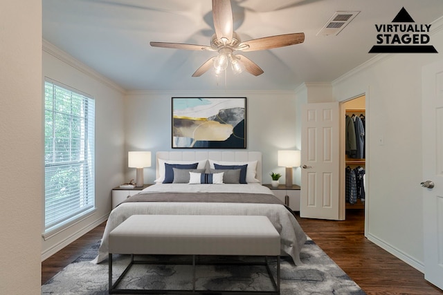 315 Lakeside Dr, Rockwall, TX 75032 - bedroom featuring dark wood-style flooring, crown molding, a walk in closet, a ceiling fan, and baseboards