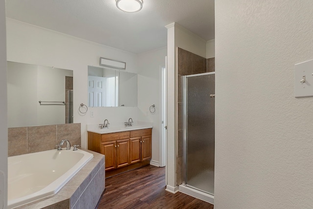 315 Lakeside Dr, Rockwall, TX 75032 - full bath featuring a garden tub, a stall shower, wood finished floors, double vanity, and ornamental molding