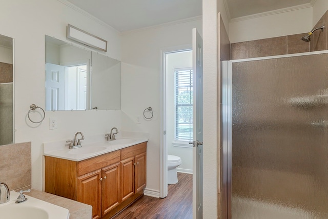 315 Lakeside Dr, Rockwall, TX 75032 - full bathroom with a shower stall, ornamental molding, toilet, wood finished floors, and double vanity