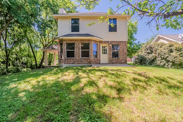 315 Lakeside Dr, Rockwall, TX 75032 - rear view of property featuring brick siding, a chimney, a yard, and a patio