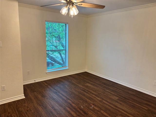 empty room featuring baseboards, ornamental molding, ceiling fan, and wood finished floors
