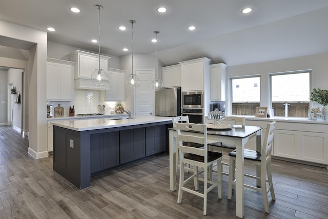 kitchen with light countertops, white cabinetry, tasteful backsplash, and stainless steel appliances