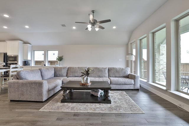 living area with a ceiling fan, visible vents, plenty of natural light, and lofted ceiling