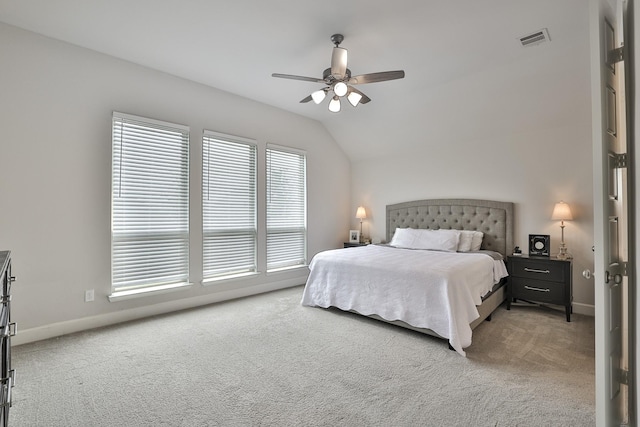 bedroom with carpet floors, a ceiling fan, baseboards, lofted ceiling, and visible vents