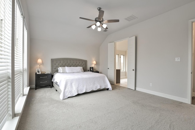 carpeted bedroom with a ceiling fan, baseboards, visible vents, and vaulted ceiling