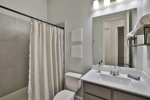 full bathroom with vanity, a textured wall, shower / bath combo, and toilet