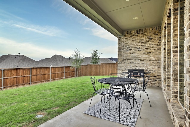 view of patio with a fenced backyard, outdoor dining space, and area for grilling