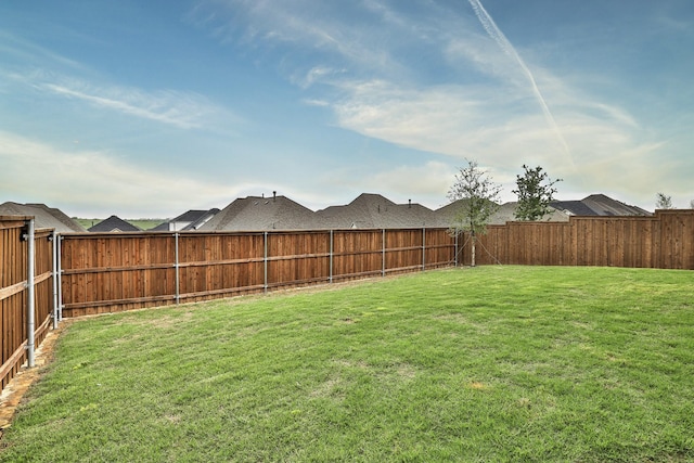view of yard with a fenced backyard