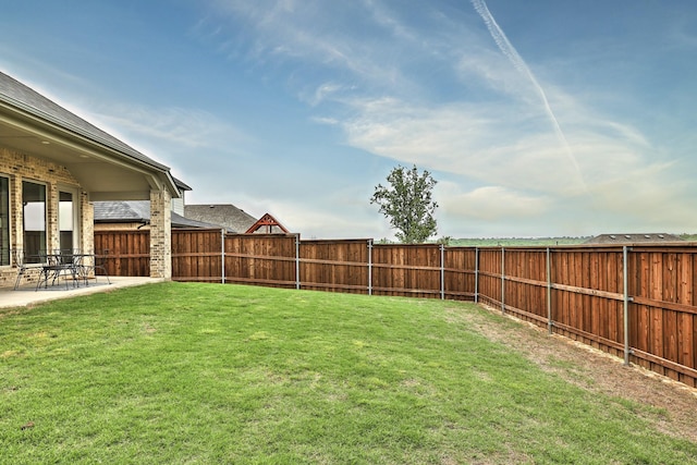 view of yard with a patio and a fenced backyard