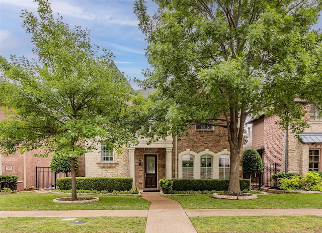 5473 Braemar Dr, Frisco, TX 75034 - view of front facade featuring fence, a gate, a front lawn, and brick siding