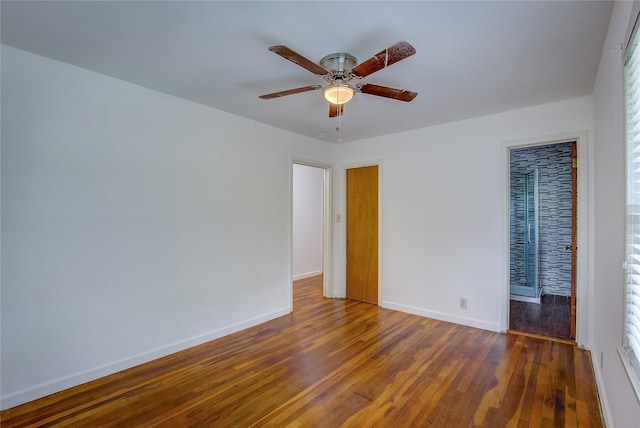 spare room with baseboards, a ceiling fan, and wood finished floors