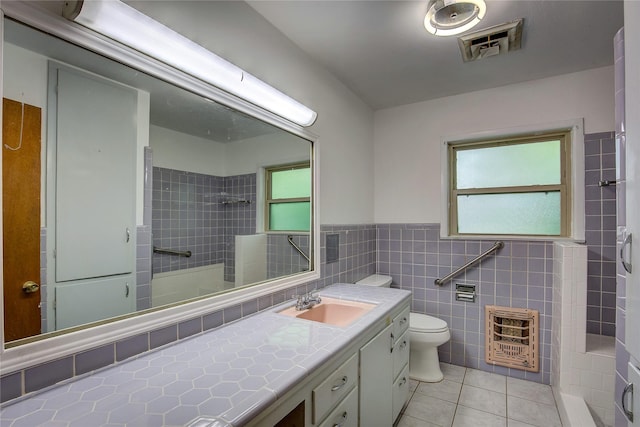 bathroom featuring visible vents, tile patterned flooring, heating unit, toilet, and walk in shower