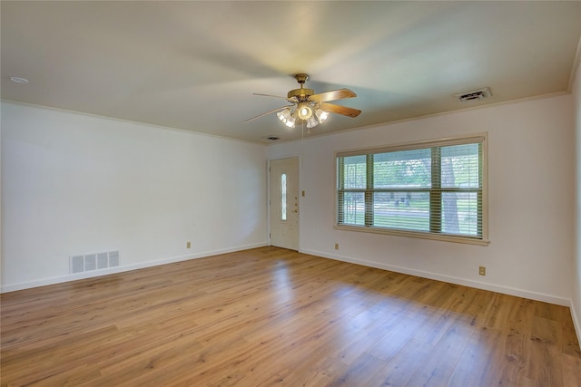 unfurnished room with visible vents, a ceiling fan, baseboards, and wood finished floors