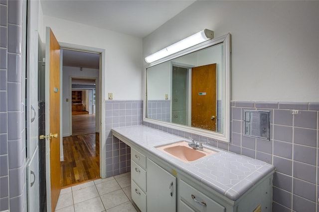 bathroom featuring tile walls, a wainscoted wall, vanity, and tile patterned floors