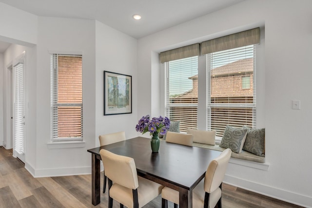 dining space with recessed lighting, baseboards, and wood finished floors