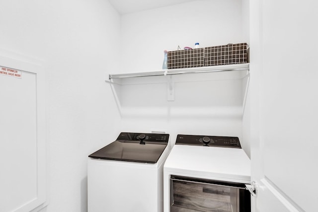 clothes washing area with washer and dryer and laundry area