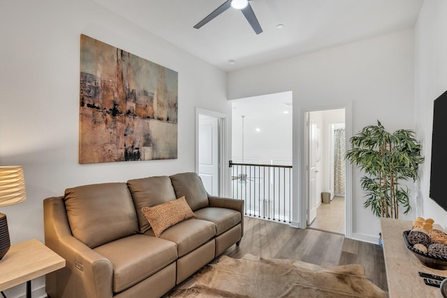 living room with a ceiling fan and wood finished floors