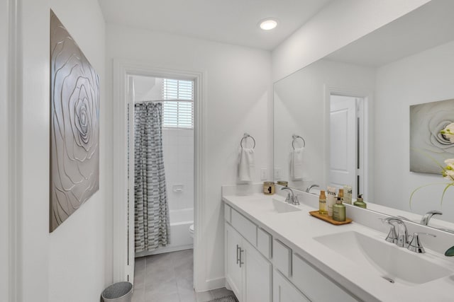 full bath with double vanity, a sink, tile patterned flooring, and toilet
