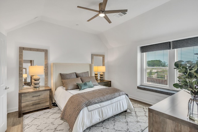 bedroom featuring baseboards, ceiling fan, vaulted ceiling, and light wood finished floors