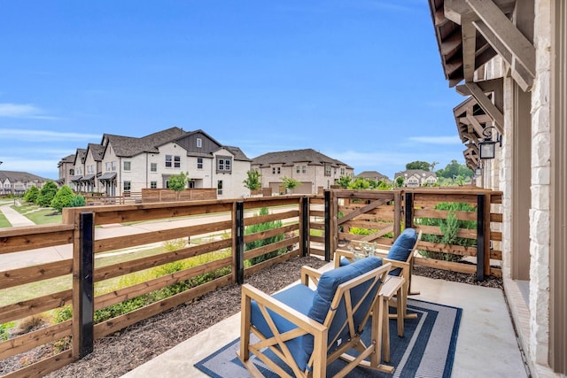view of patio / terrace with a residential view and a balcony