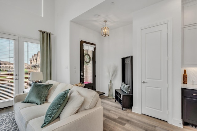 living room featuring an inviting chandelier and light wood-type flooring