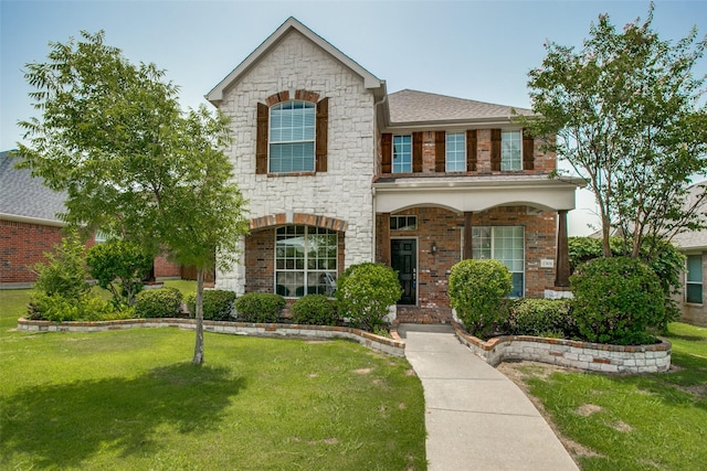 2501 Del Largo Way, Frisco, TX 75033 - traditional-style house featuring brick siding, a front lawn, and stone siding