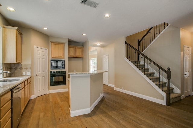 2501 Del Largo Way, Frisco, TX 75033 - kitchen with a sink, black appliances, light wood-style flooring, and visible vents