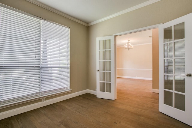 2501 Del Largo Way, Frisco, TX 75033 - empty room featuring french doors, wood finished floors, baseboards, an inviting chandelier, and ornamental molding
