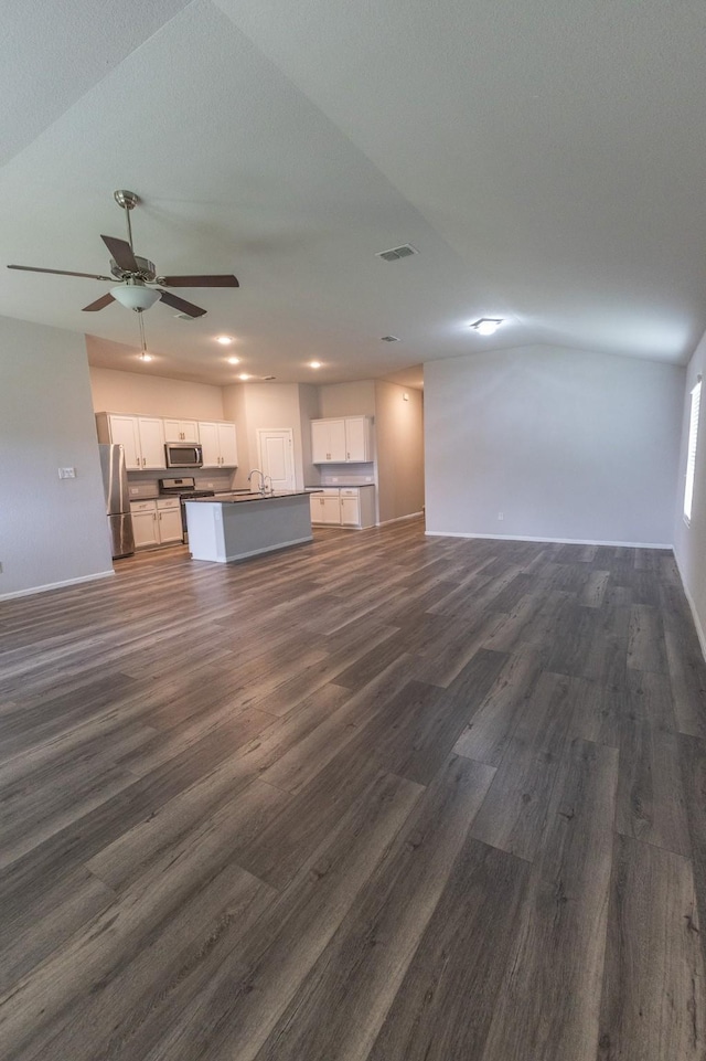 6000 Sutton Fields Trl, Celina, TX 76227 - unfurnished living room featuring dark wood-style flooring, a ceiling fan, visible vents, and baseboards