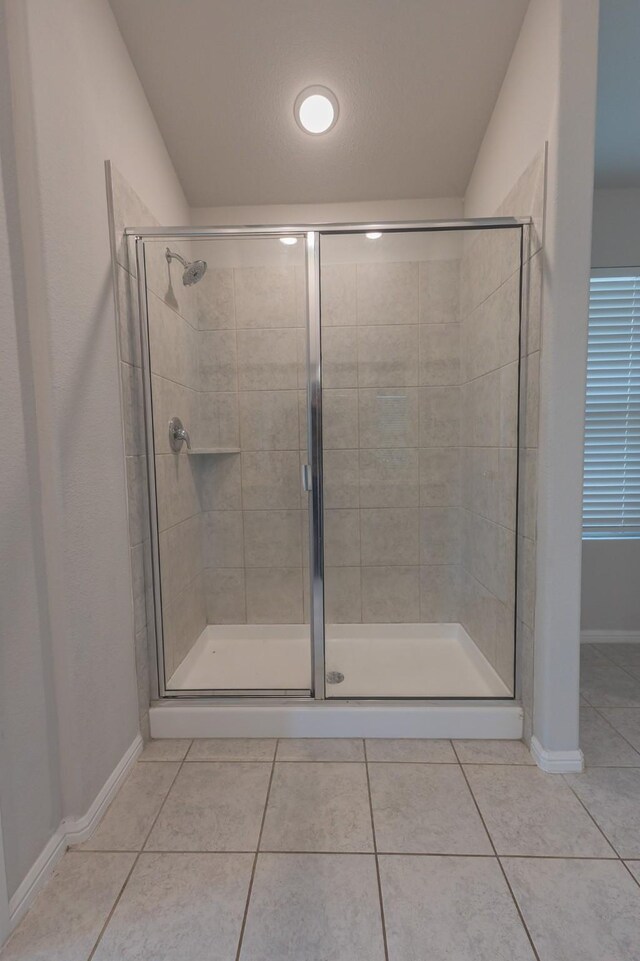 6000 Sutton Fields Trl, Celina, TX 76227 - full bathroom featuring baseboards, tile patterned flooring, and a shower stall