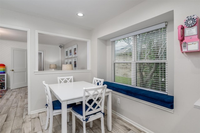 dining room featuring baseboards, recessed lighting, and wood finished floors