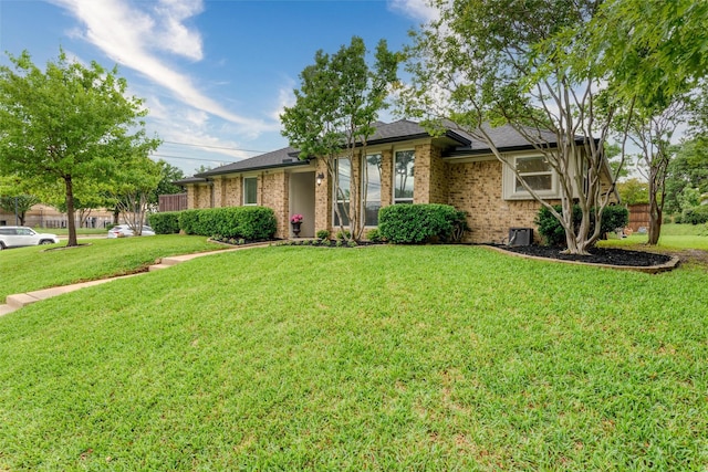 ranch-style house with brick siding and a front yard