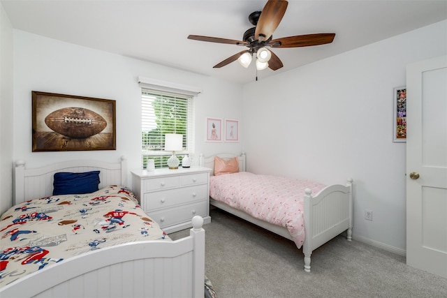 bedroom with baseboards, a ceiling fan, and light colored carpet