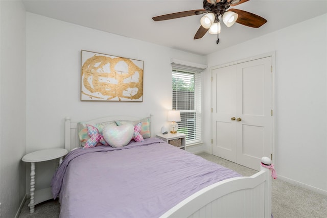 carpeted bedroom with baseboards, a ceiling fan, and a closet