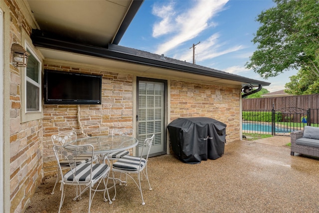 view of patio / terrace featuring fence, outdoor dining area, and area for grilling